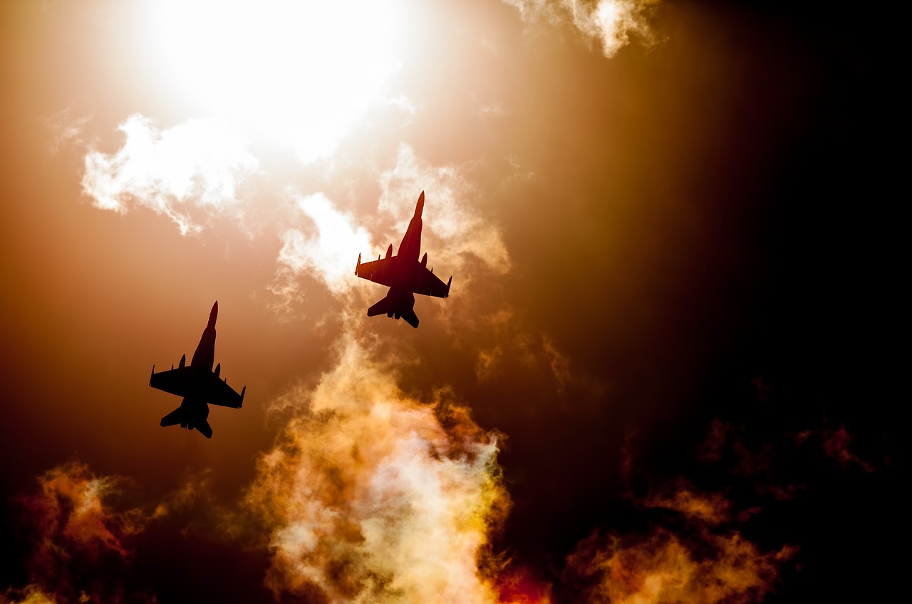 Two jets flying in formation against a cloudy sky