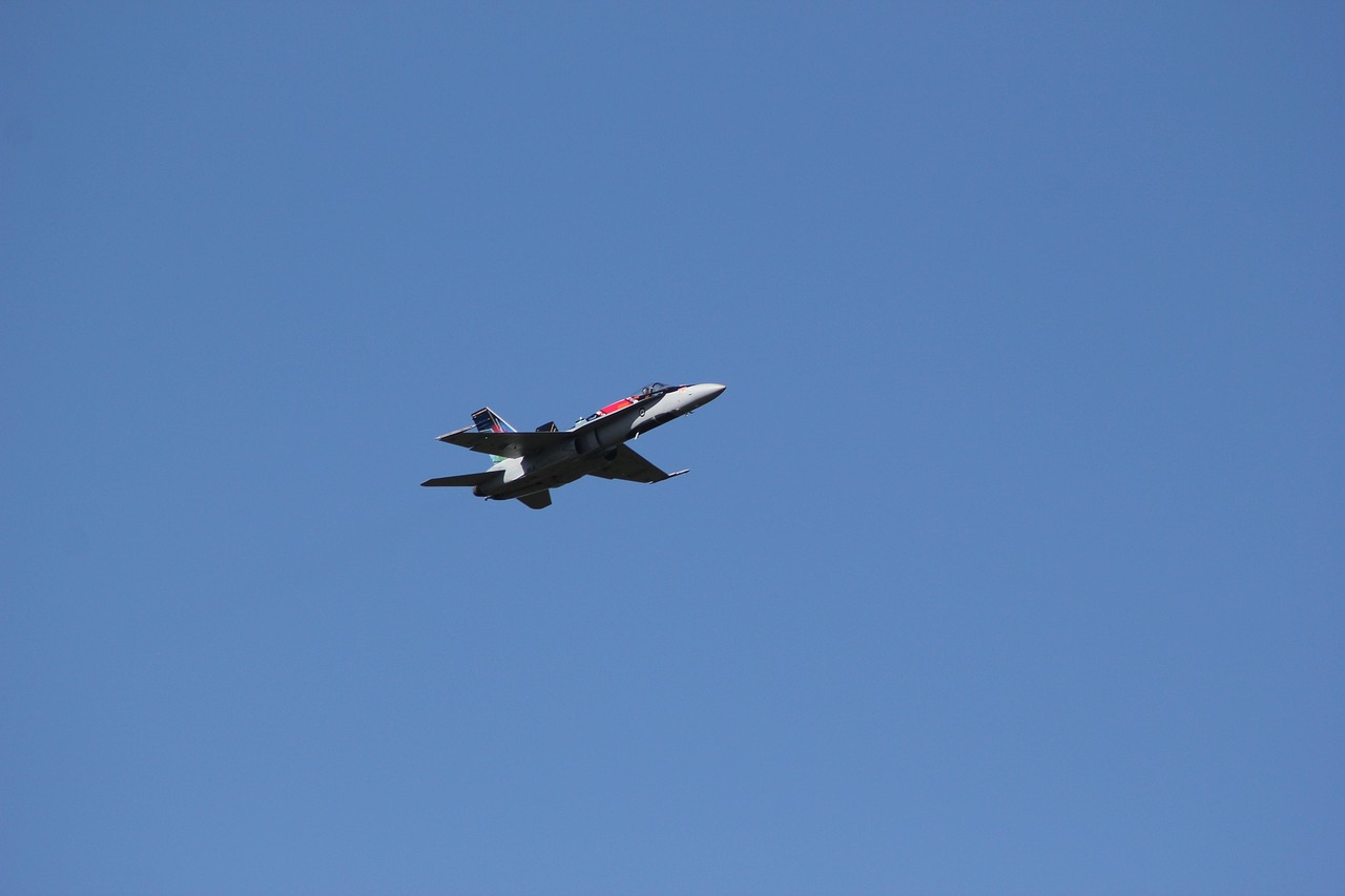A fighter jet flying in a blue sky
