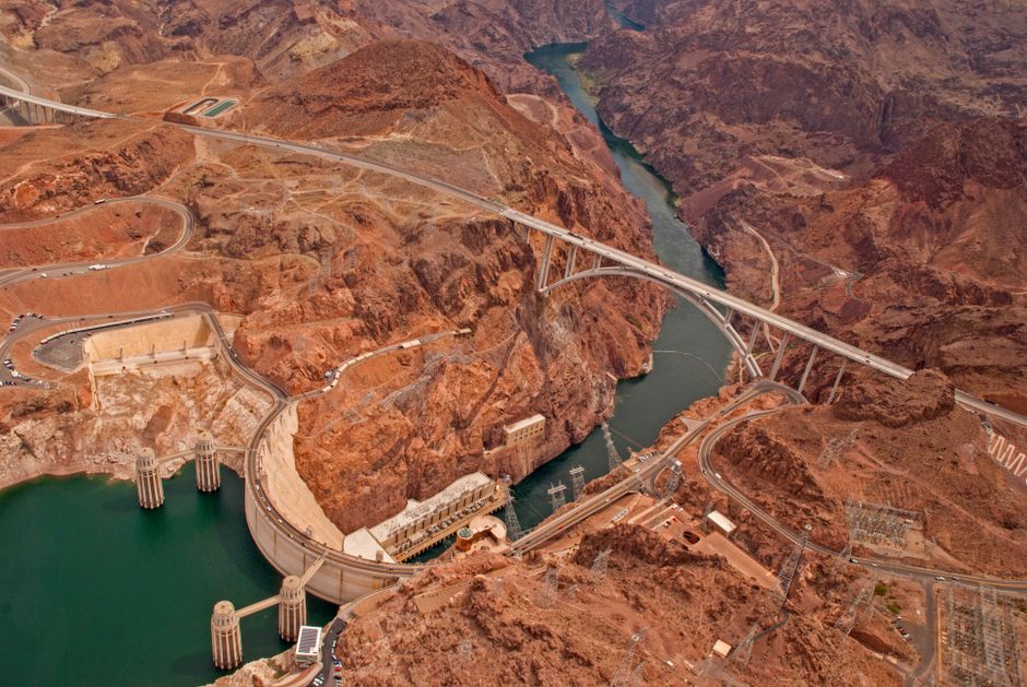 Aerial view of Hoover Dam with bridge and roads