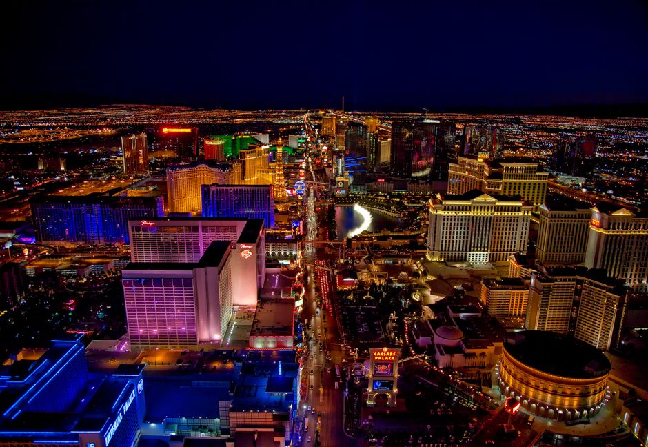 Aerial view of the Las Vegas Strip at night, showing various casinos and hotels.