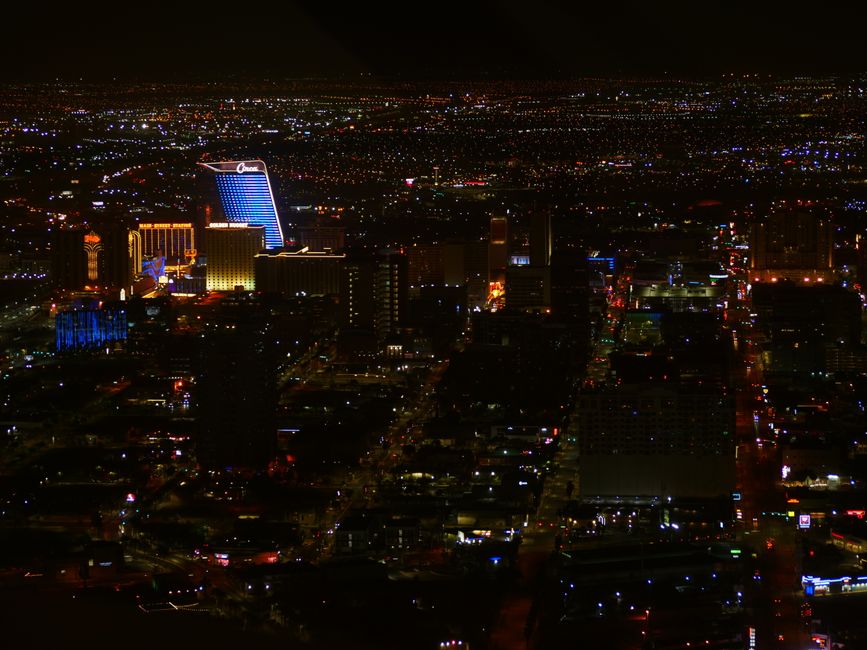 Aerial view of a city at night with many lit buildings and streets