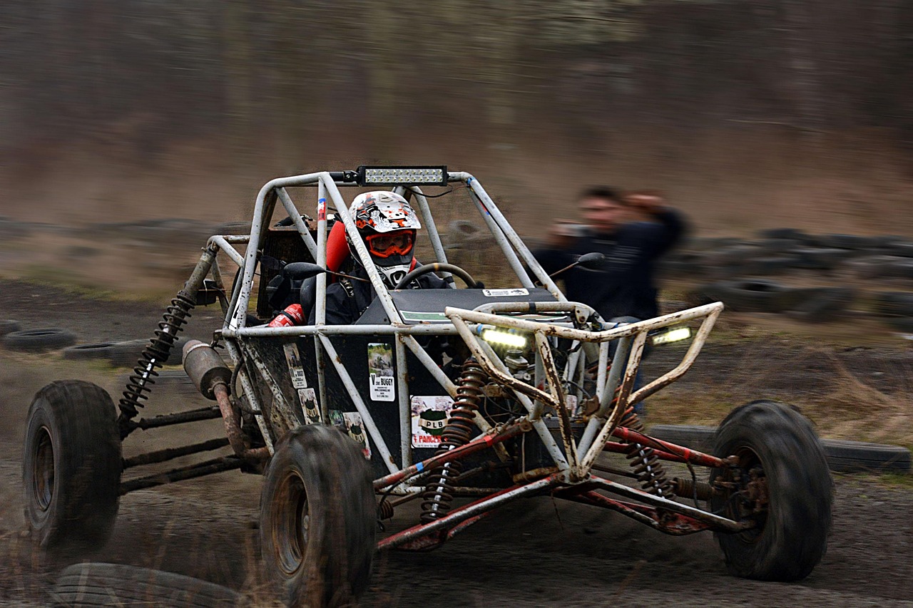 Off-road buggy with a driver on a dirt track