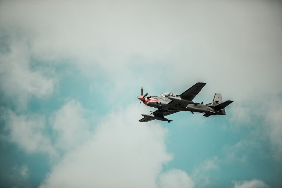a small propeller plane flying in the sky
